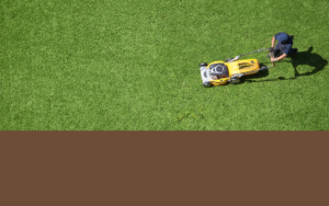 Top Dow View Of Someone Cutting Grass On Commercial Lot